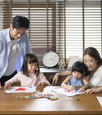 Asian family with children Drawing and painting on table